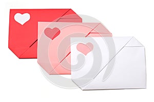 Red, pink and white paper envelopes with colored hearts on white background isolated. Love, Valentine`s day, mother`s day