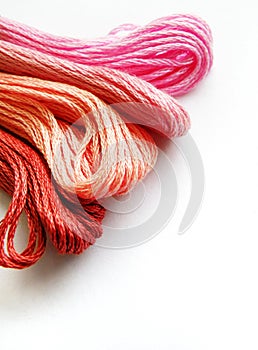 Red and pink yarn, white background