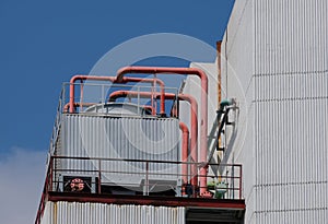 Red pipes and corrugated facade