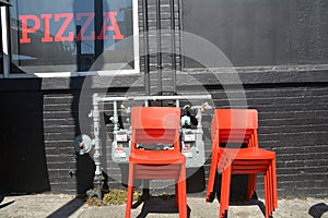 Red pizza sign and orange chairs in Portland, Oregon