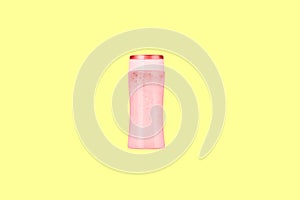 Red plastic bottle with shampoo. Shampoo bottle on a yellow background. Cosmetic product for washing hair and hands without a