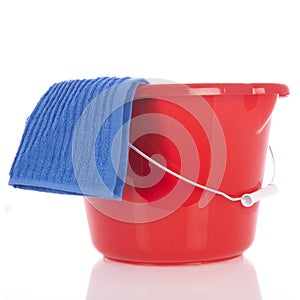Red plastic bucket with blue cloth