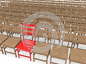 Red plastic chair between wooden chairs