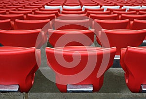 Red plastic chairs at the stadium