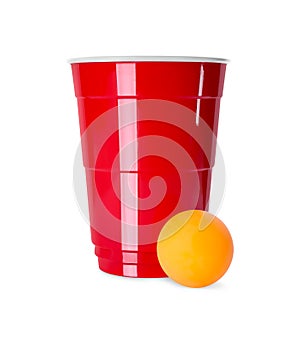 Red plastic cup and ball for beer pong on background