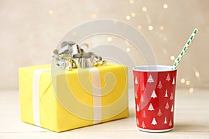 Red plastic cup and yellow gift