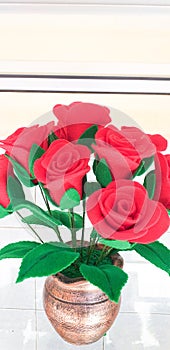 Red plastic flowers in the glass cabinet