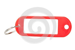 Red plastic key tag or label close up isolated on white background.