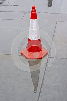 A red plastic road traffic warning cone