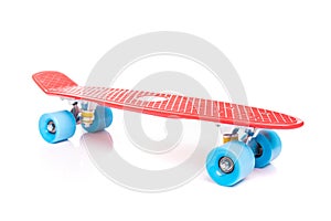 Red plastic skateboard on white background