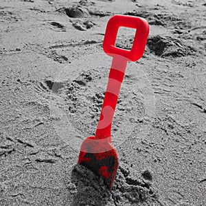 Red Plastic Spade on Beach