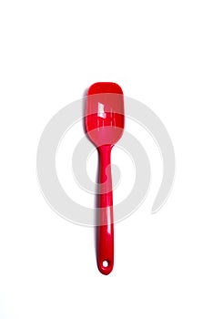 Red plastic spoon on isolated