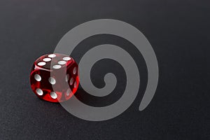 Red playing dice on black table. Luck and fortune concept