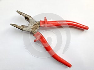Red pliers isolated on white background close-up top view. Hardware store