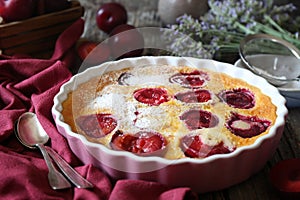 Red plums clafoutis flan, icing sugar dressing, french cuisine