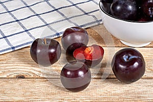 Red plums on wooden background photo