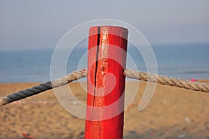 Red pole on the beach