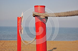 Red pole on the beach