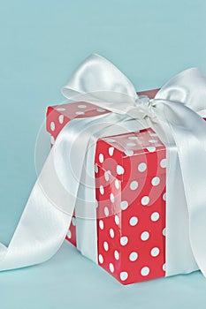 Red polkadot gift box with white bow