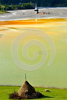 Red polluted lake and flooded church in Romania, Geamana photo