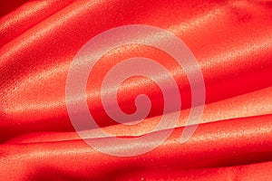 Red polyester canvas, naturally lit, textured background photo