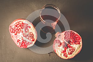 Red pomegranate juice in a glass/Pomegranate fruit and juice in glass on dark background, top view