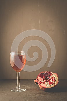 Red pomegranate juice in a glass/Red pomegranate juice in a glass on a dark background with copyspace