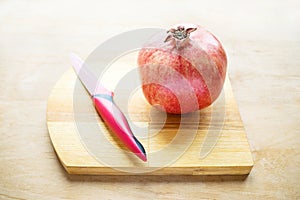 Red pomegranate and red knife. How to Deseed a Pomegranate. Hea