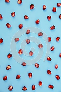 Red pomegranate seeds isolated on background. Healthy fruits, vegan food, diet. Flat lay. Top view.