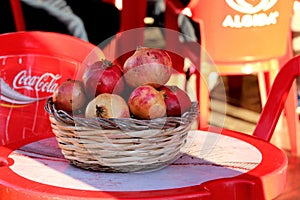 Red pomegranates on small table