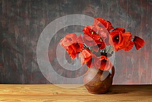 Red poppies in a ceramic vase