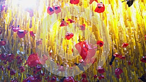 Red poppies and yellow grass made from plastic bags. Outdoor canopy