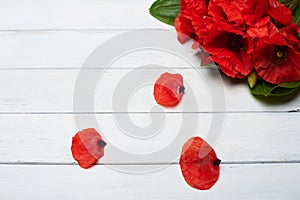 Red poppy flowers on white wood table