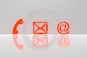 Red Popular Contact Web Icons On Desk Over The Reflective Desk Against Gray Wall. 3D rendering