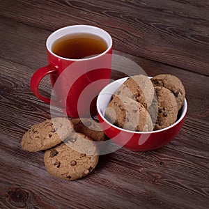 Red porcelain tea mug and sweet cookies