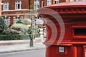 Red post box on a street in London, UK