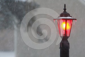 Red Post Light Shining During a Winter Storm