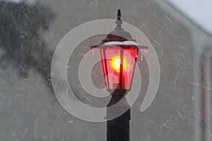 Red Post Light Shining During a Winter Storm