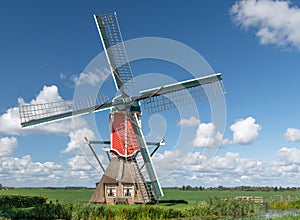 Traditional red post mill in a meadow, Rode Molen, Oud Ade, the Netherlands photo
