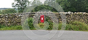 Red postbox in Drystone wall