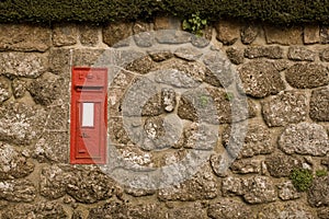Red Postbox in English Village Wall
