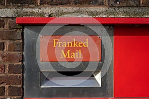 A red postbox with the words franked mail above it