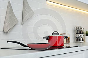 Red pot and frying pan on stove