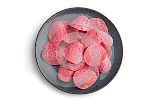 red potato chips with herbs and tomatoes isolated on white background. Top view, close up