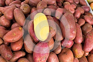 Red potatoes in a market display with half cutted