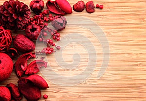 Red potpourri on wood with copy space