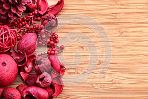 Red potpourri on wood with copy space