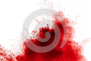 Red powder explosion on white background. Freeze motion of red dust particles splash