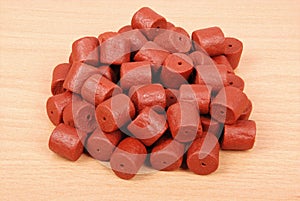 Red pre-drilled halibut pellets