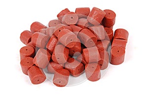 Red pre-drilled halibut pellets